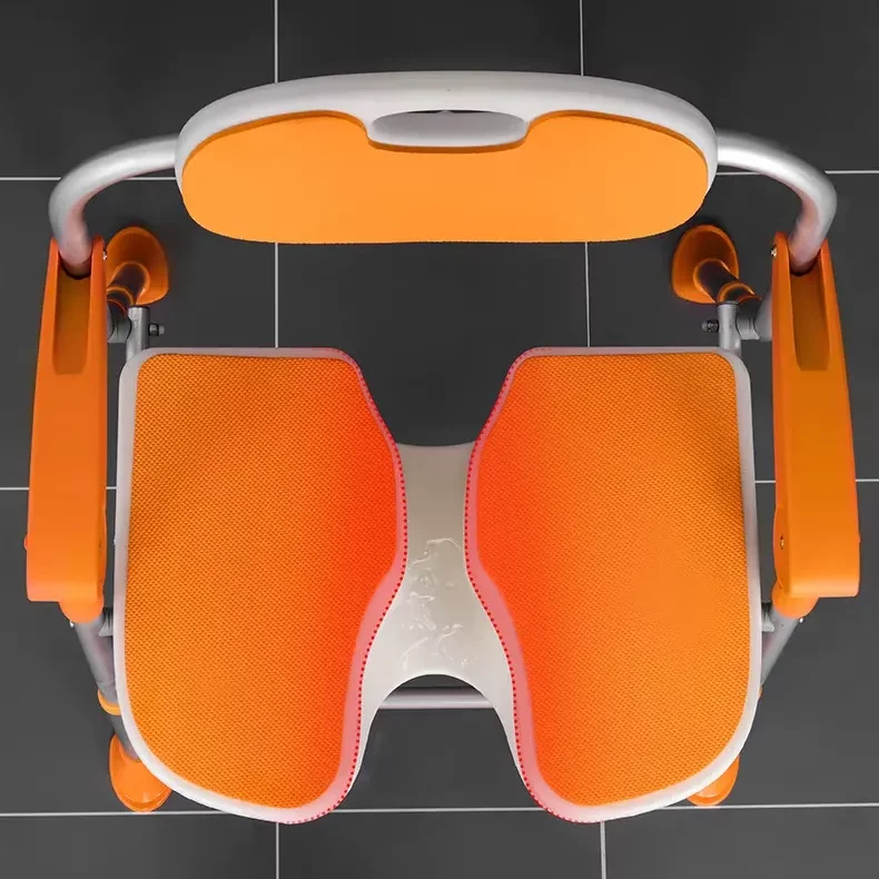 Existing AryMD orange folding bath chair image showing orange split seat and arm supports from above