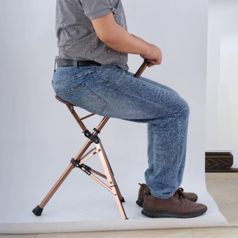 Existing AryMD folding cane seat image showing adult seated on the open three-leg cane seat